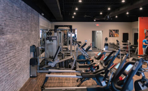 Modern Apex Personal Fitness gym interior in Niagara Falls NY with treadmills, strength machines, and free-weight training stations.