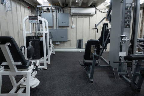 Multi-station cable machine and leg curl equipment in weight room at Apex Personal Fitness Youngstown NY