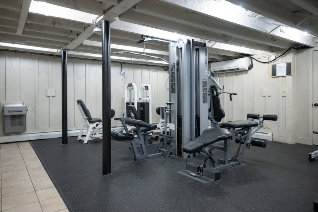 Multi-station cable machine and leg curl equipment in weight room at Apex Personal Fitness Youngstown NY