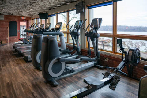 Elliptical trainers with large windows overlooking outdoor view at Apex Personal Fitness Youngstown NY