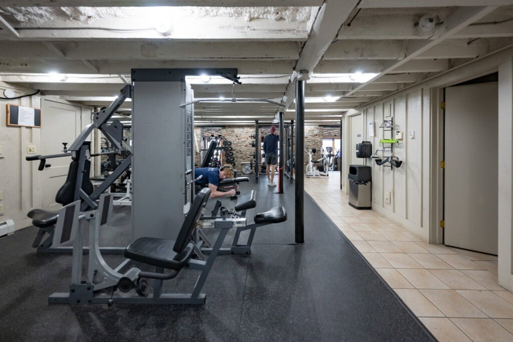 Member using leg press machine in strength training area at Apex Personal Fitness Youngstown NY