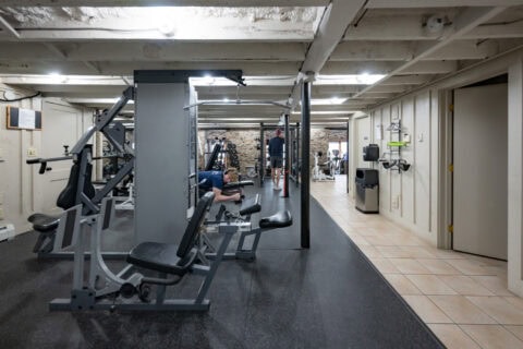 Member using leg press machine in strength training area at Apex Personal Fitness Youngstown NY