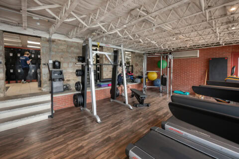 Member training on cable machine in open gym floor at Apex Personal Fitness Youngstown NY