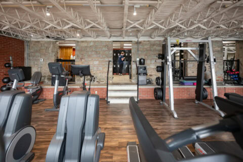 Rowing machines and cardio equipment on gym floor at Apex Personal Fitness Youngstown NY