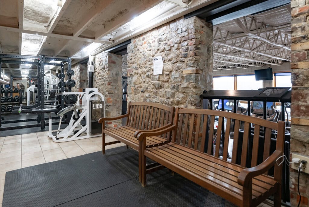 Weight machines and stone wall interior at Apex Personal Fitness gym Youngstown NY